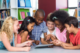 Students interacting with tablet device